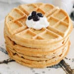stack of protein waffles topped with greek yogurt and blueberries.