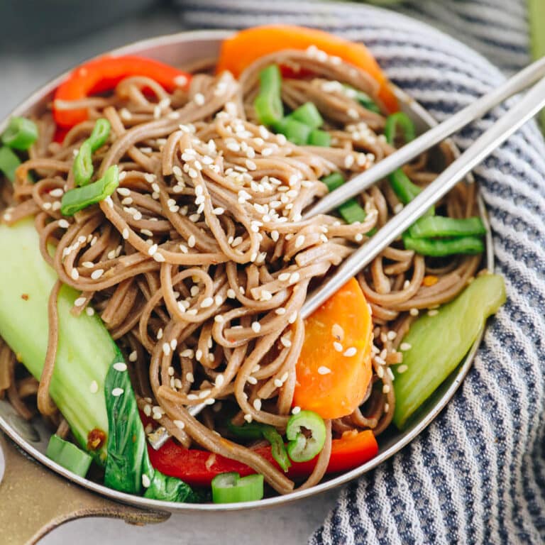 sesame soba noodle recipe in a small dish with metal chopsticks.