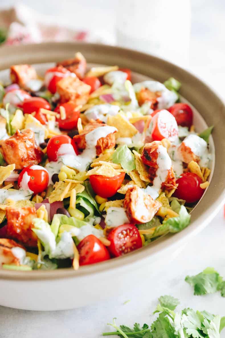 BBQ chicken salad in a large salad bowl with ranch dressing.