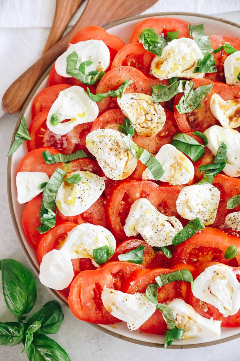 tomato burrata salad with sprinkled basil, olive oil, salt and pepper