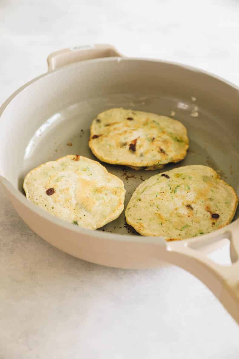 cooked zucchini pancakes in the pan.