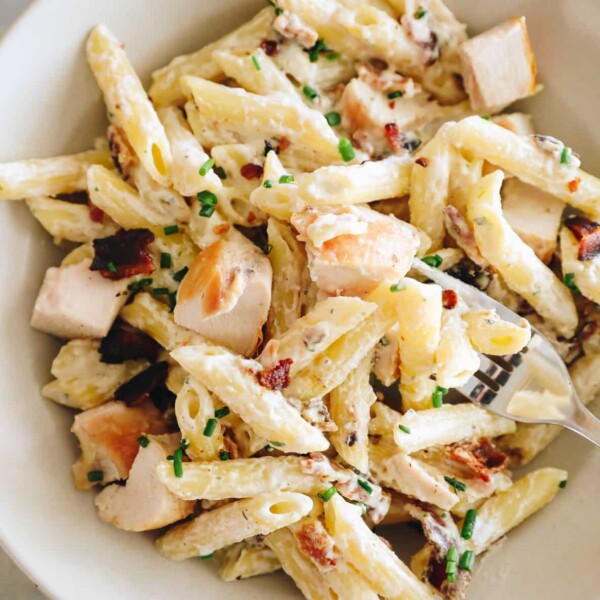 creamy chicken bacon ranch pasta in a shallow white bowl.