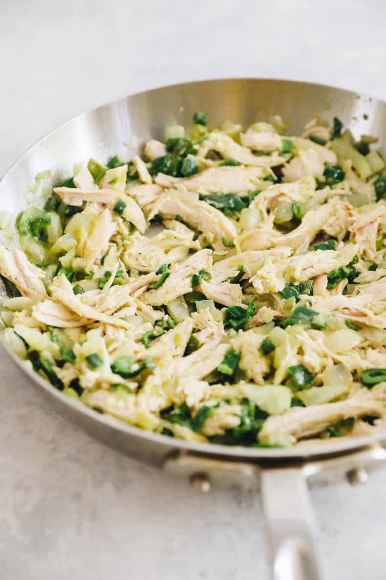 rotisserie chicken, poblano peppers and onions in a pan.