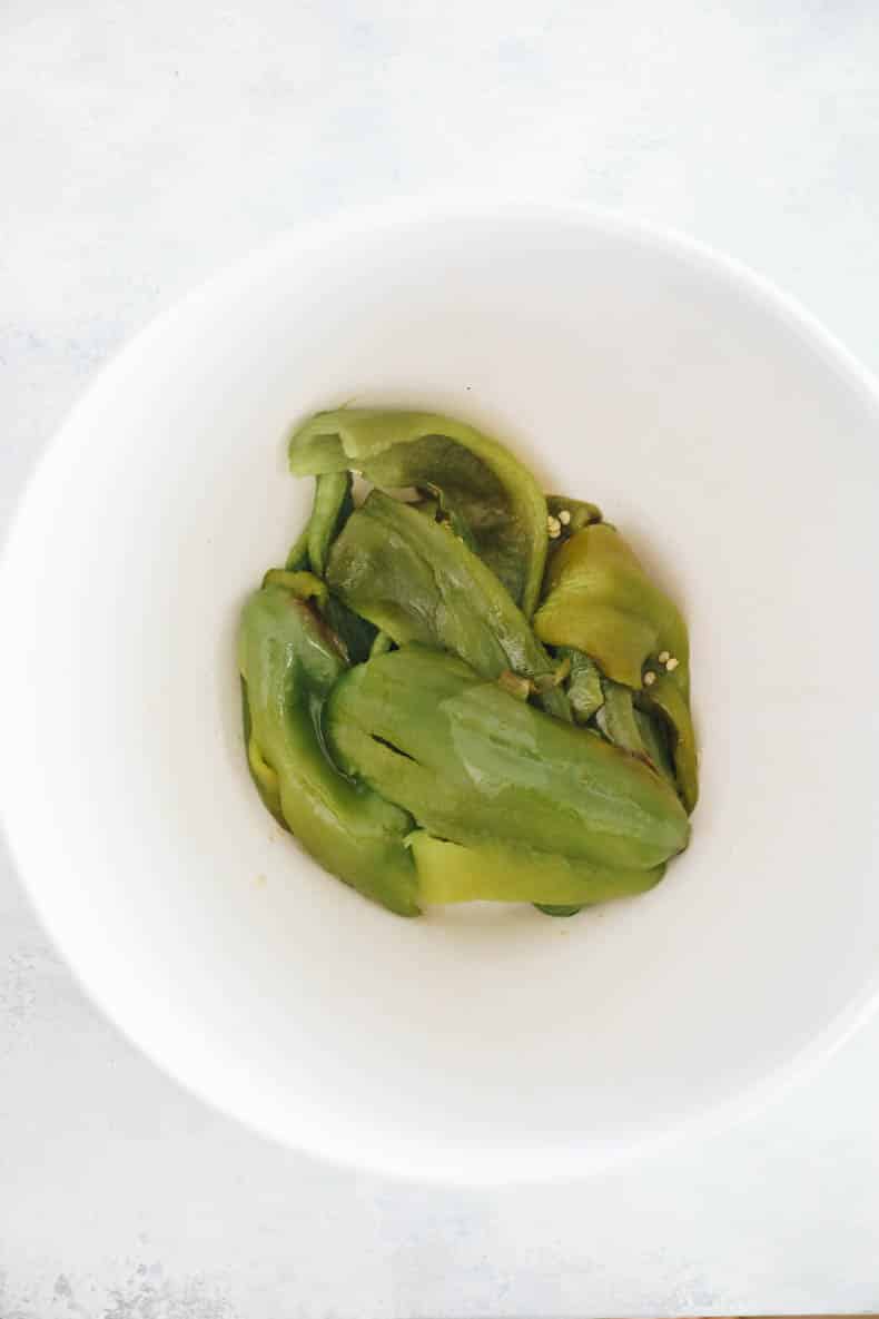 peeled hatch peppers in a bowl.