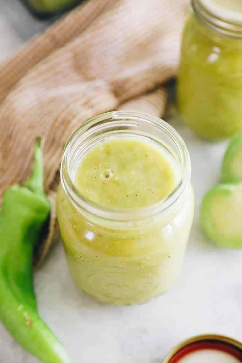 green enchilada sauce in a small pint mason jar.