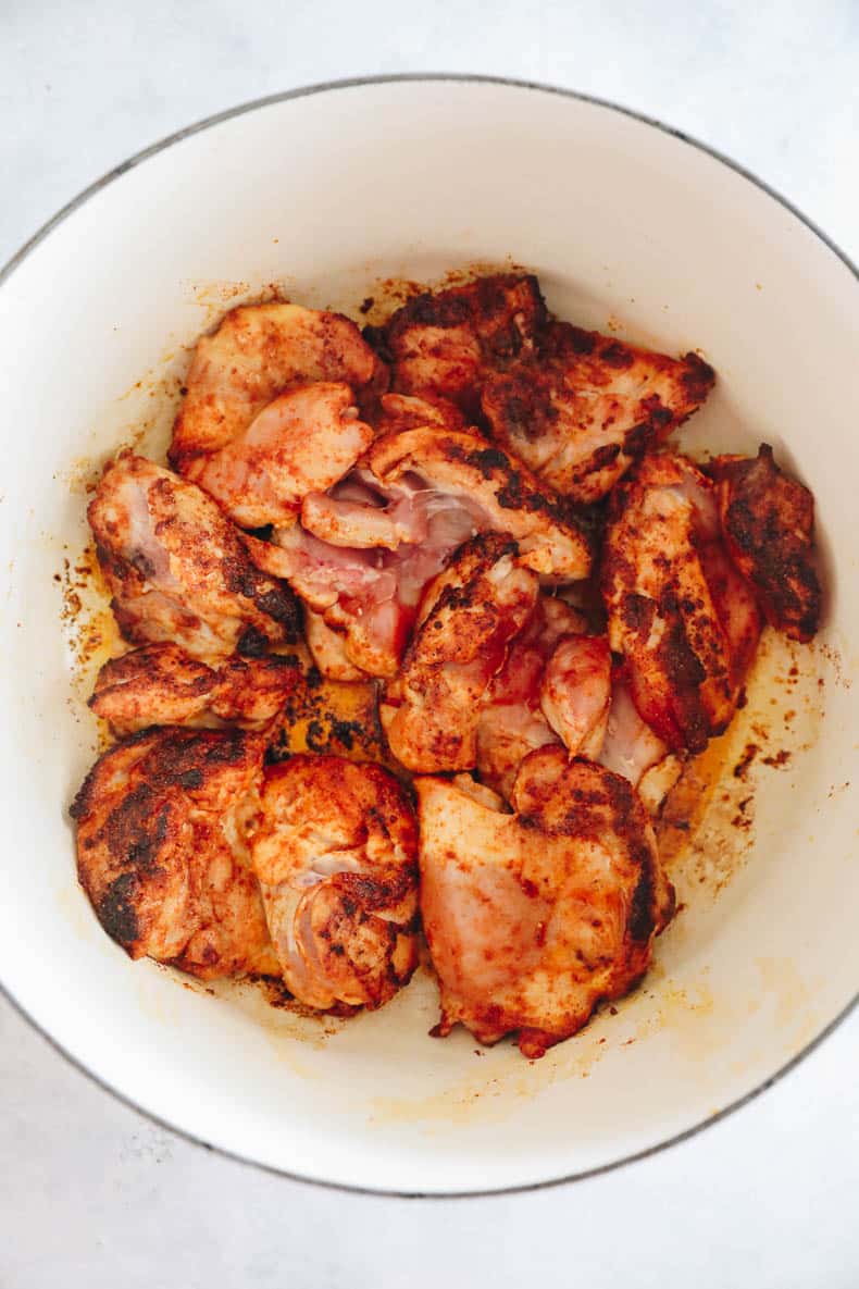 browned chicken thighs in a dutch oven.