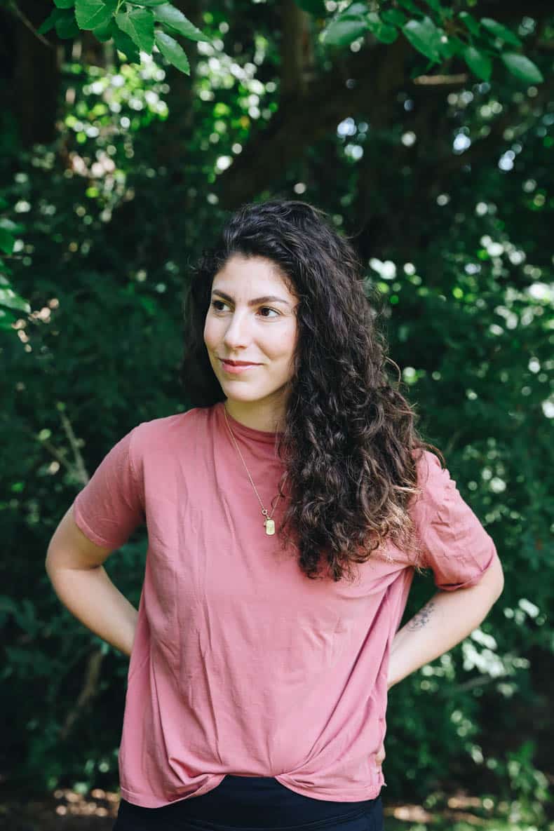 Young woman wears MERIT beauty products on her face.