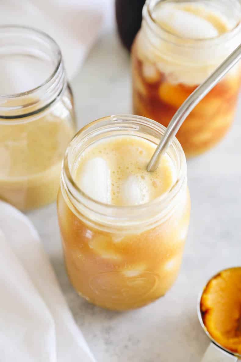 pumpkin cream cold brew on ice in a mason jar.