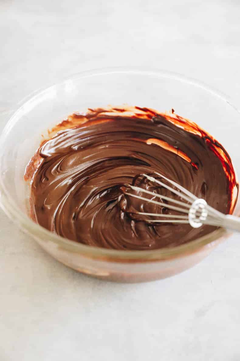 Melted chocolate and butter in a glass mixing bowl.