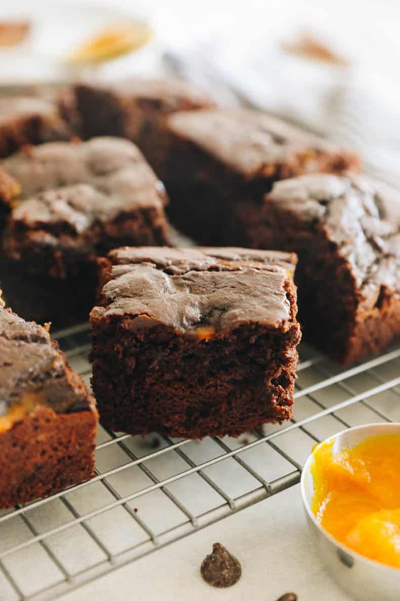 close-up image of pumpkin brownies on a wire rack.