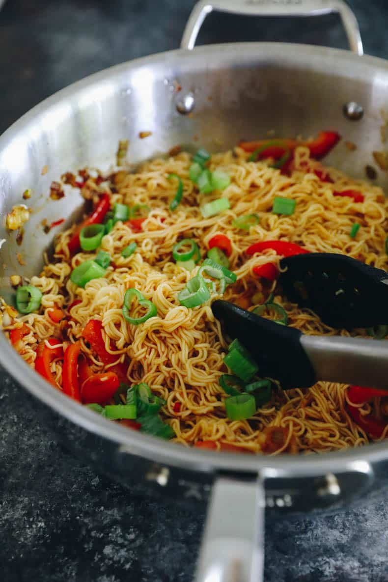 spicy ramen noodles in a large wok.