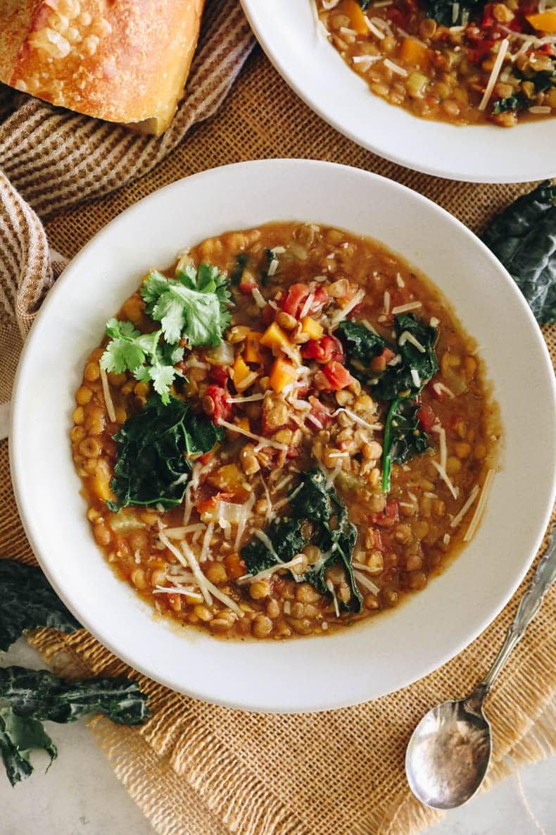 Overhead image of Instant Pot Lentil Soup in a white shallow bowl.