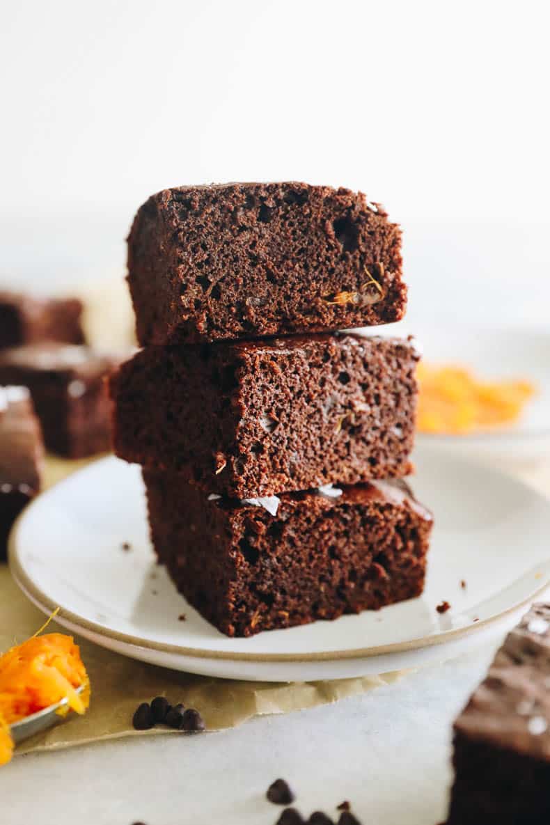 fudgy sweet potato brownies stacked high on a plate.