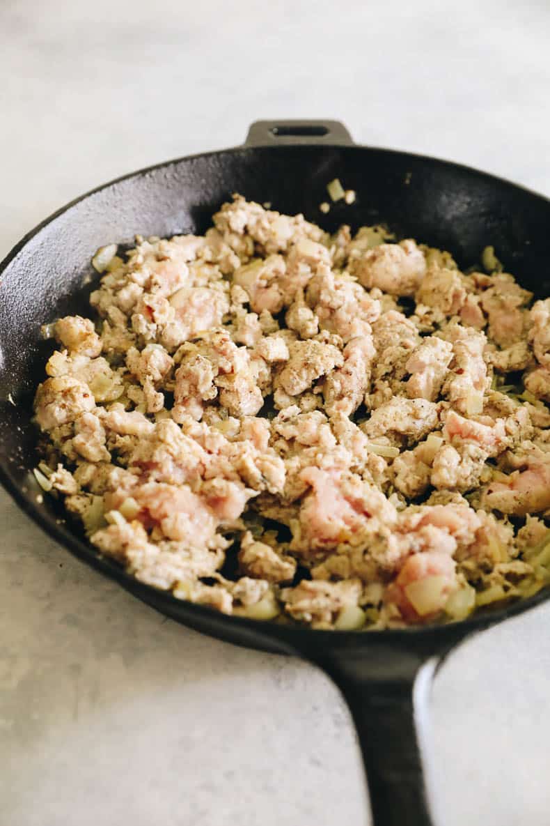 ground turkey and onion cooked in a cast-iron skillet