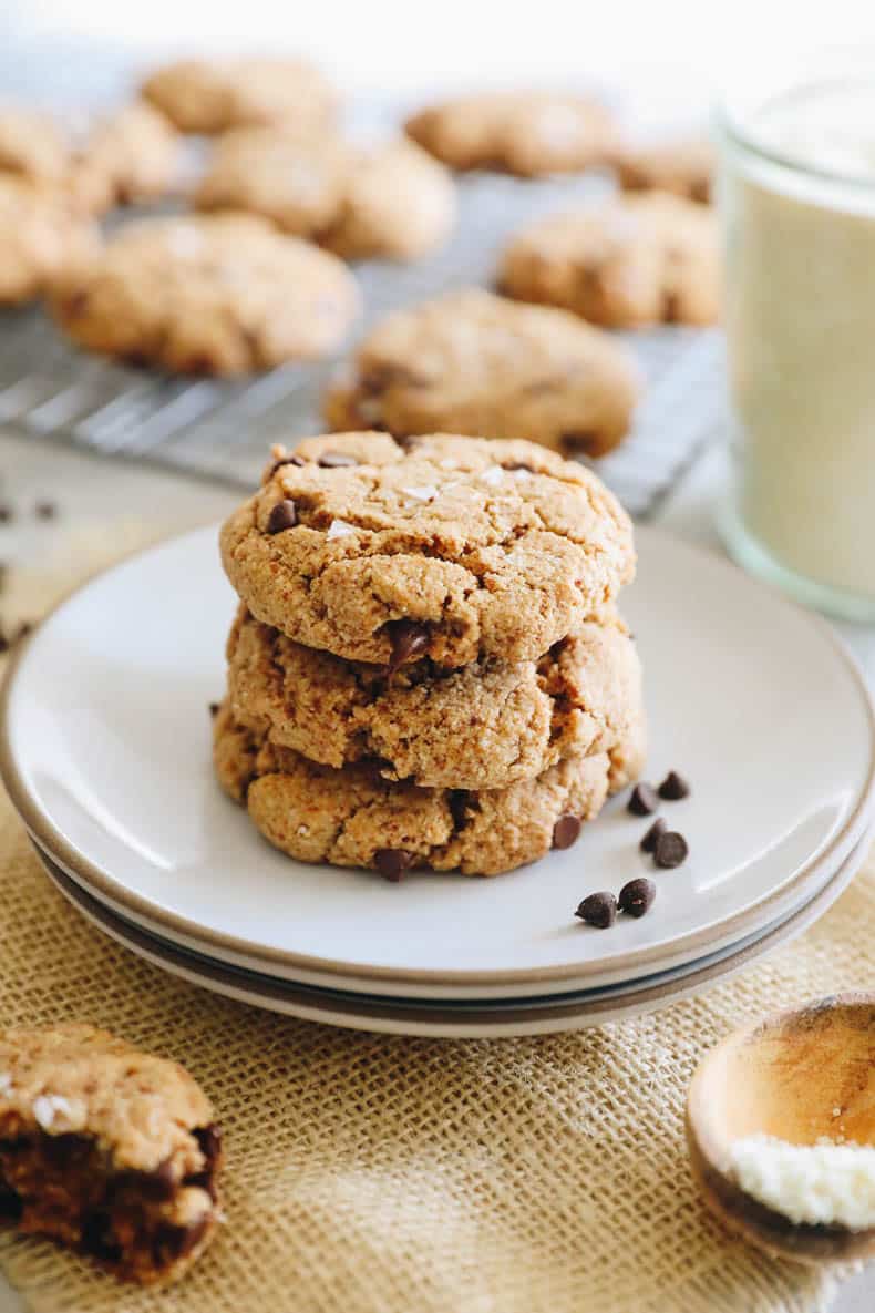 almond cookies with chocolate chips on white plates.