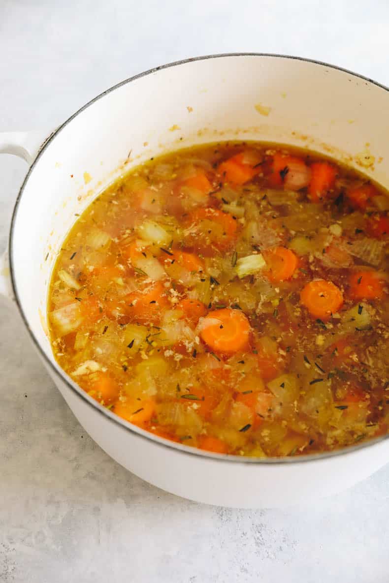 Roasted carrot soup in a large soup pot.