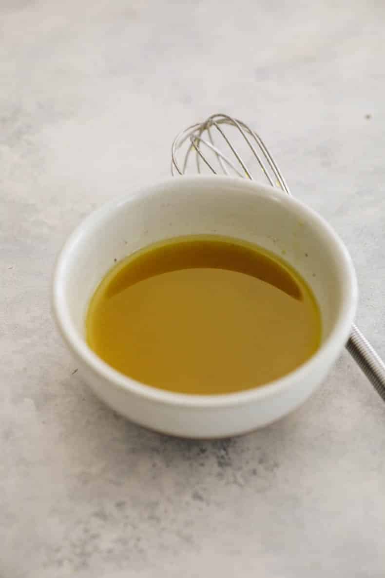salad dressing in a small white bowl.