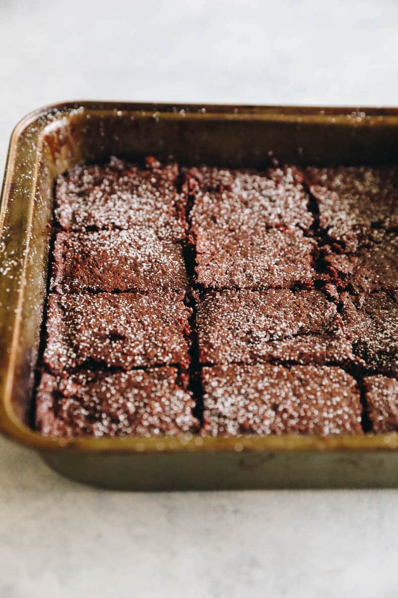 baked almond flour brownies topped with powdered sugar.