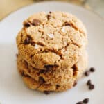 almond flour cookies stacked on top of each other with chocolate chips and maldon sea salt.