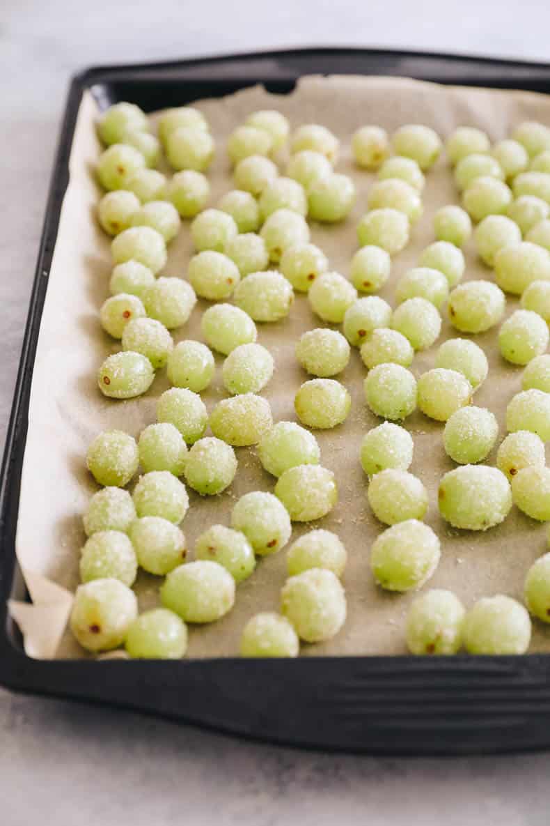 candy grapes on a baking sheet with parchment paper