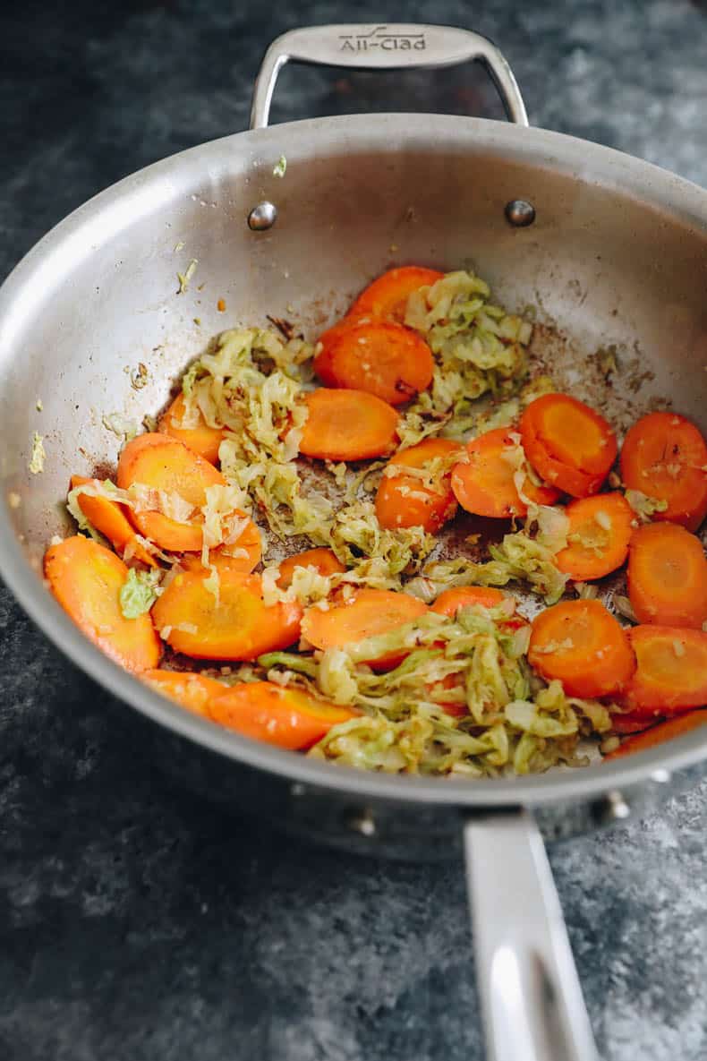 cooked carrots and cabbage in a wok.