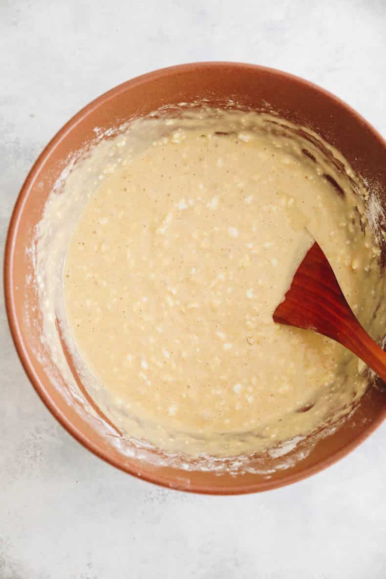 cottage cheese pancake batter in a large brown mixing bowl.