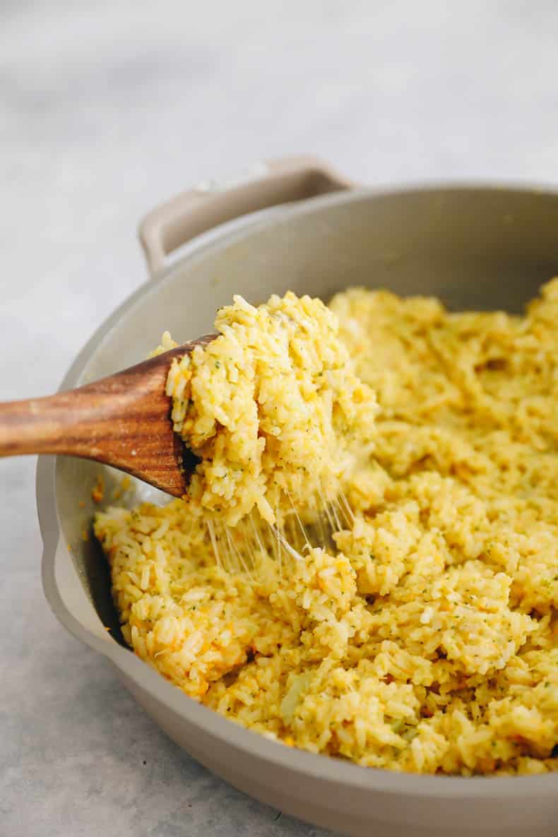 melted cheesy rice with veggies in a non-stick pan