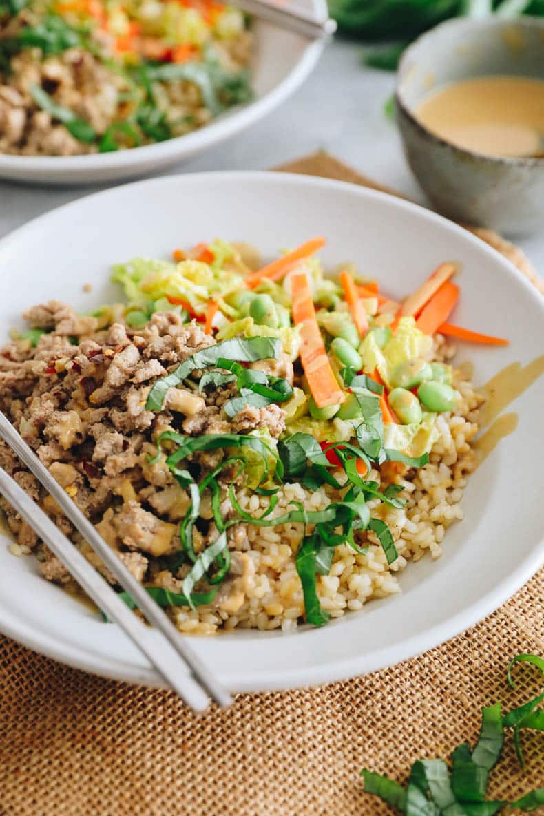 Thai bowl with ground turkey, sliced thai basil, carrots, edamame, cabbage and green onions topped with a peanut sauce.