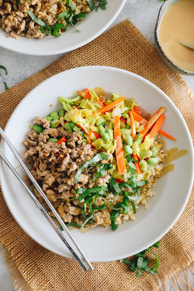 overhead image of turkey thai bowls in a white bowl with chopsticks.