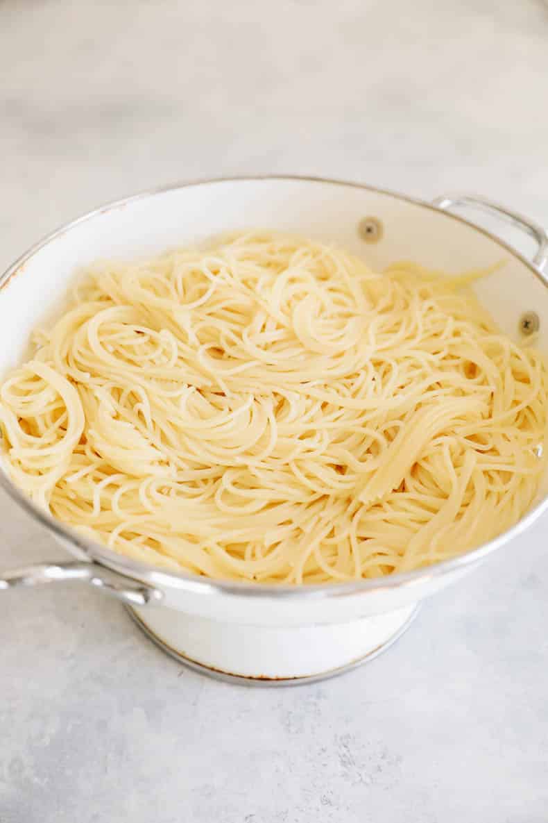 angel hair pasta in a colander.