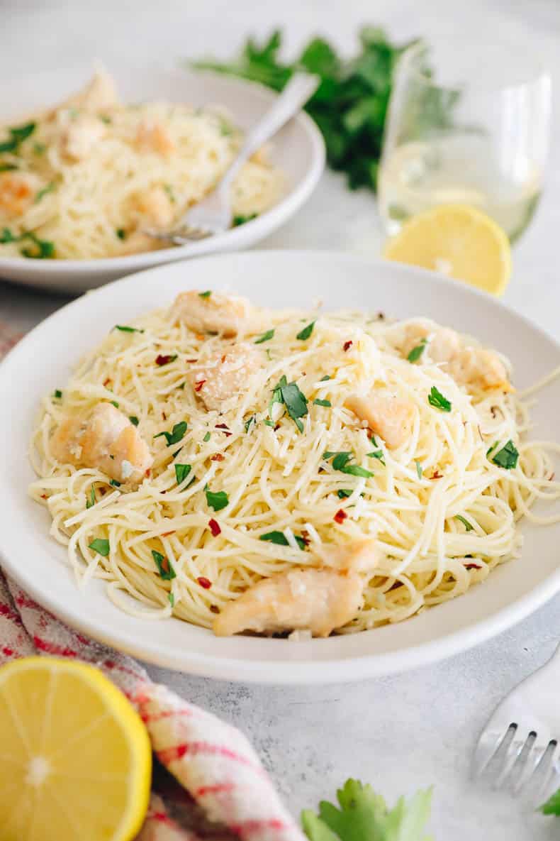 chicken scampi in a white plate with parsley.