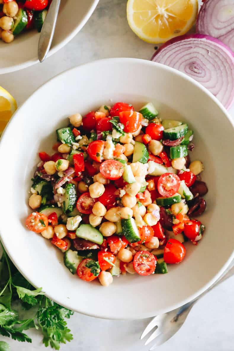 overhead image of mediterranean salad in a white bowl.