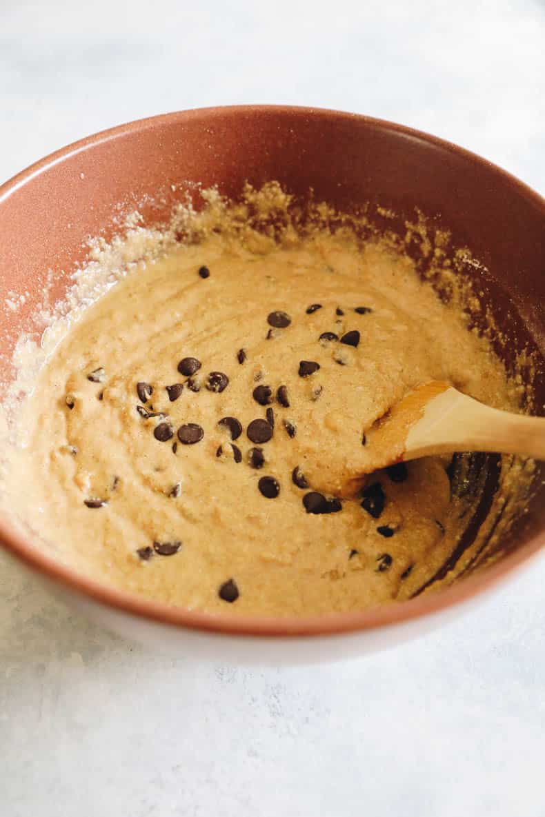 oatmeal banana bread batter with chocolate chips in a large brown bowl.