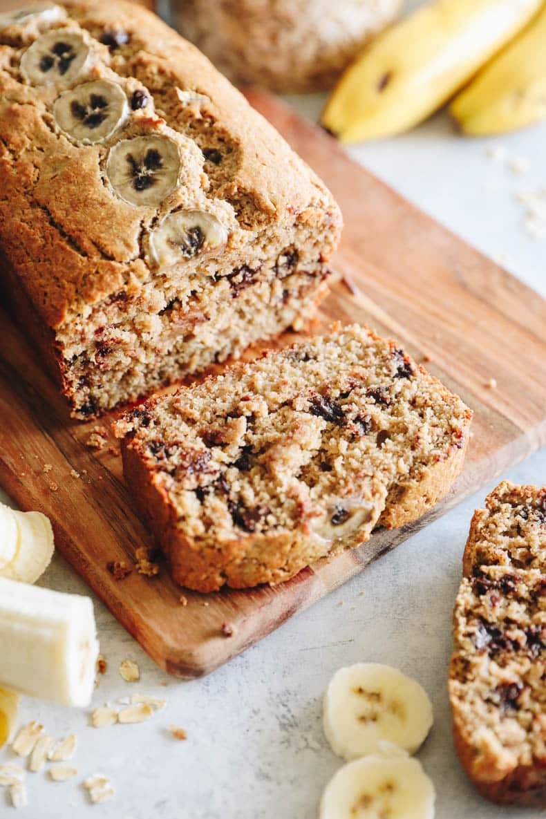 slice of oat flour banana bread on a cutting board.