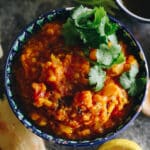 vegetable dal in a decorative bowl with cilantro garnish.