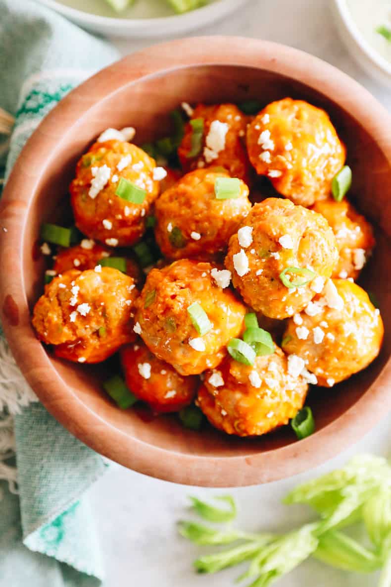 overhead of meatballs in a brown bowl.