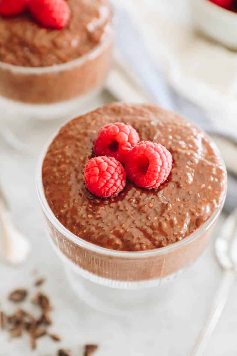 chocolate chia pudding topped with raspberries.