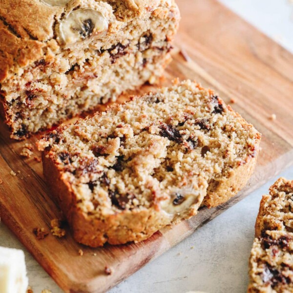 up close image of a slice of oat flour banana bread on a cutting board.