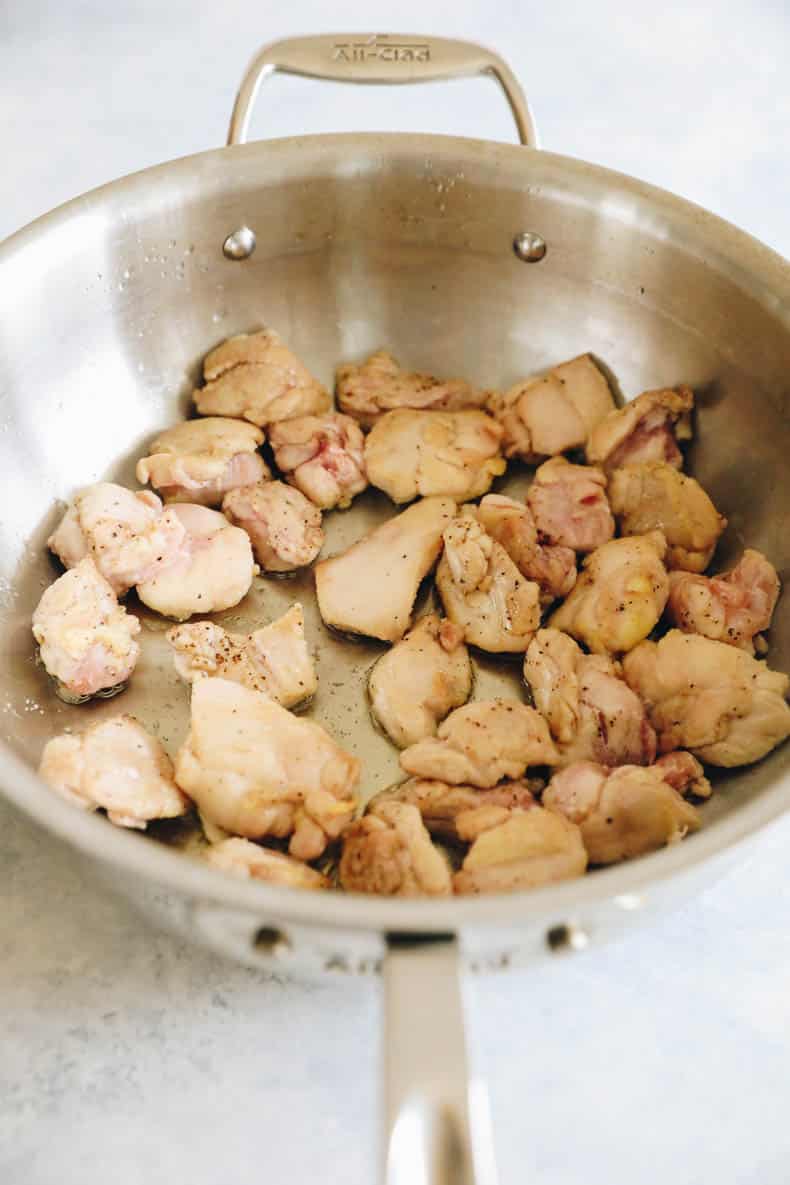 cooked chicken thighs in a wok.