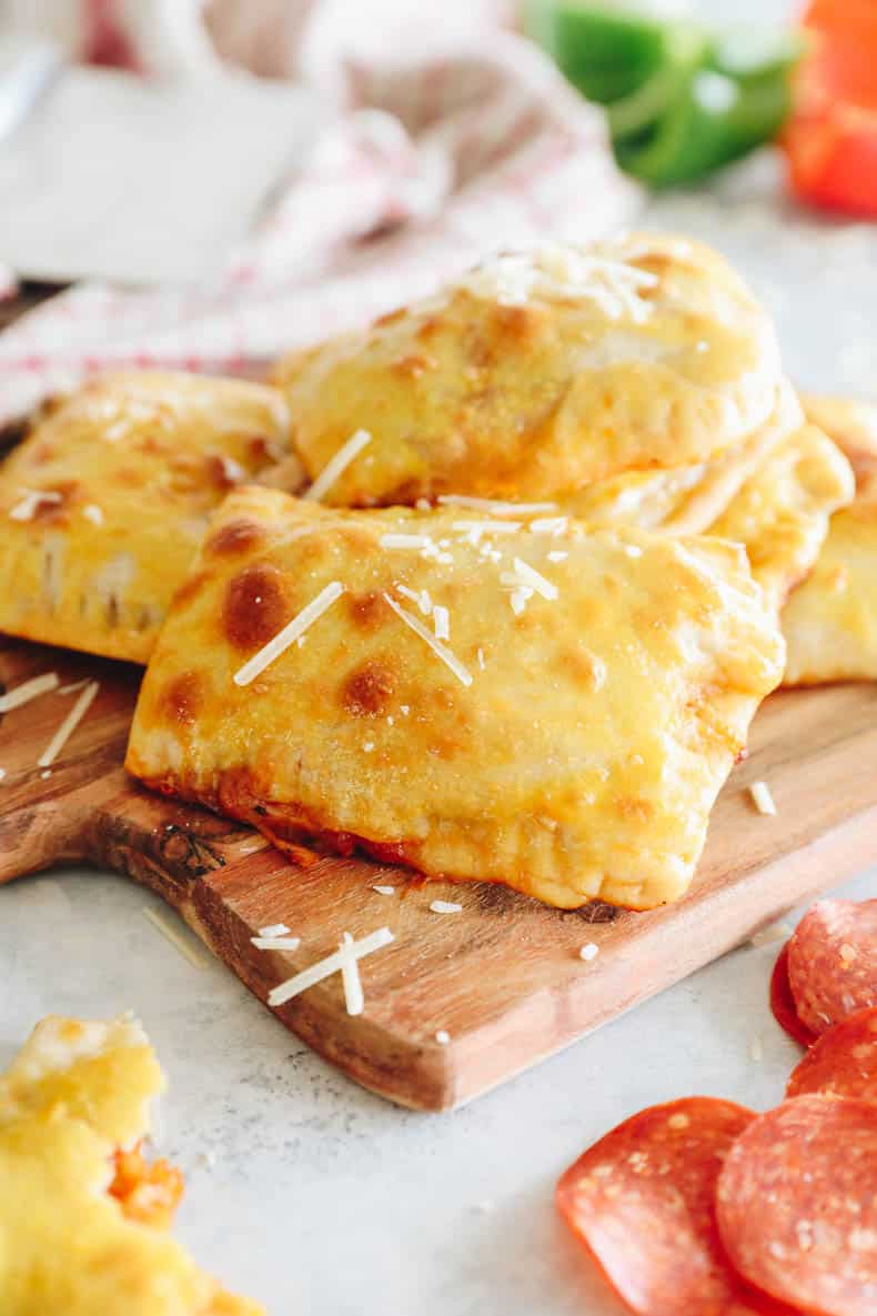 homemade pizza pockets on a wood board.
