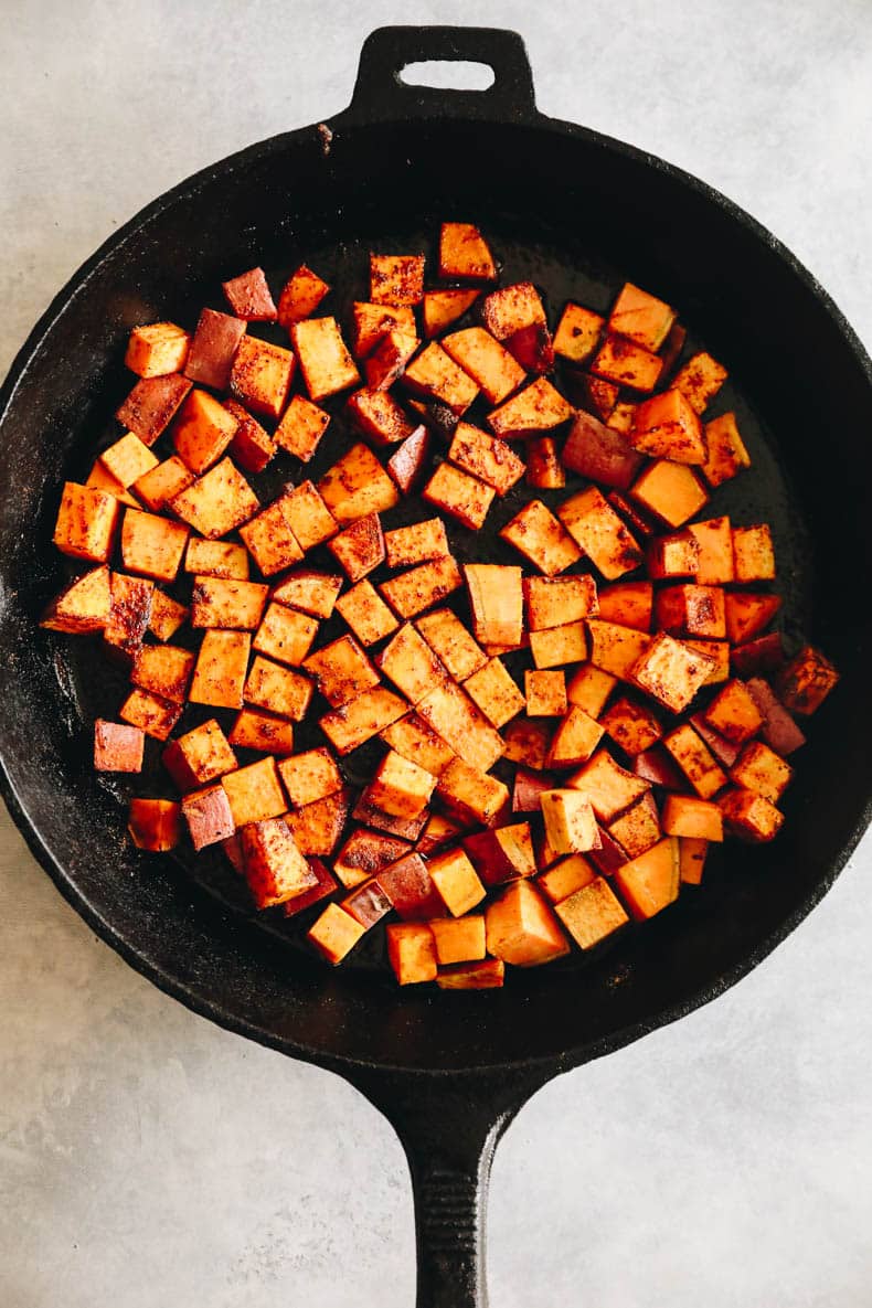 roasted sweet potatoes in a cast-iron dish.