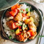 kung pao chicken recipe over rice in a green bowl.