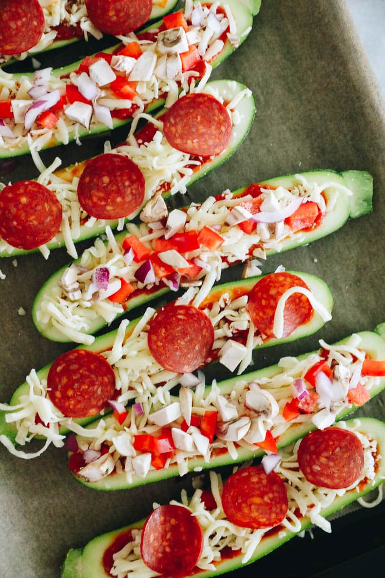 zucchini pizza boats on a baking sheet